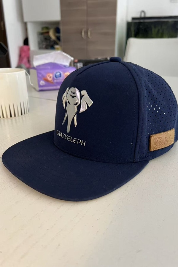 A phone photo of a navy cap on a kitchen counter